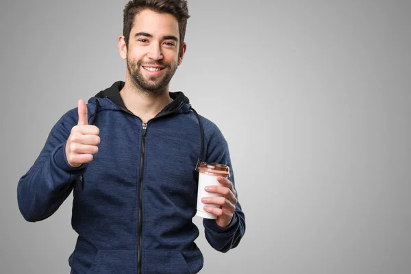 Young Man Holding Coffee Doing Okay Gesture Grey Background — Stock Photo, Image