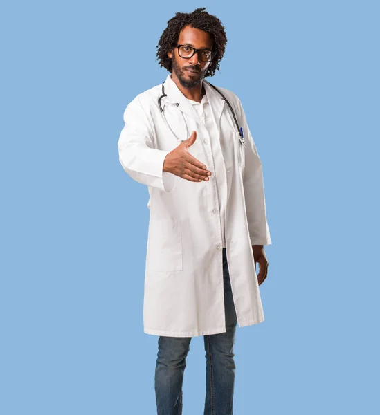 Handsome african american medical doctor reaching out to greet someone or gesturing to help, happy and excited