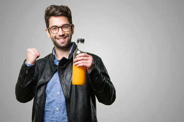 Strong Young Man Holding Orange Juice Bottle Grey Background — Stock Photo, Image