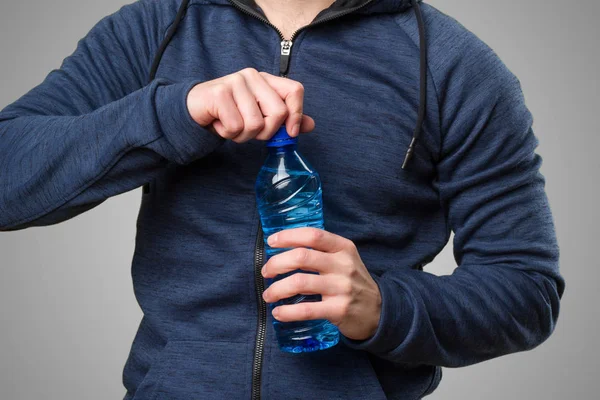 Happy Young Man Holding Bottle Water Grey Background — Stock Photo, Image