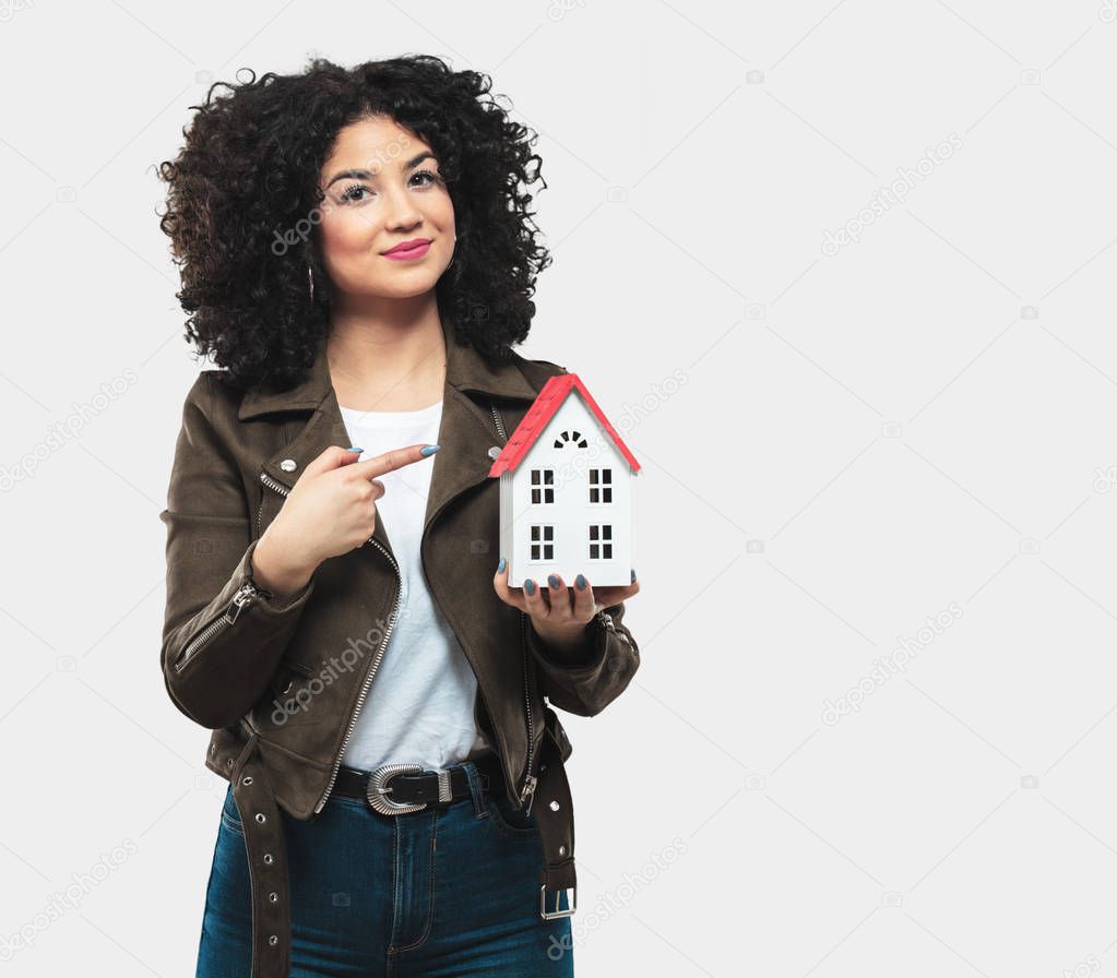 young woman holding a house model