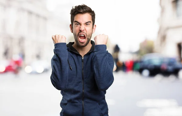 Young Man Doing Winner Gesture Blurred Background — Stock Photo, Image