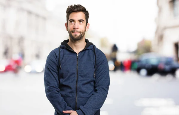 young man thinking on blurred background