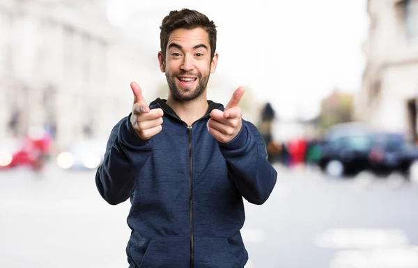 Young Man Pointing Front Blurred Background — Stock Photo, Image