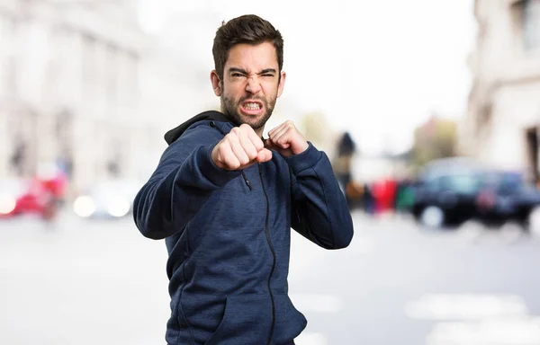 Young Man Punching Blurred Background — Stock Photo, Image