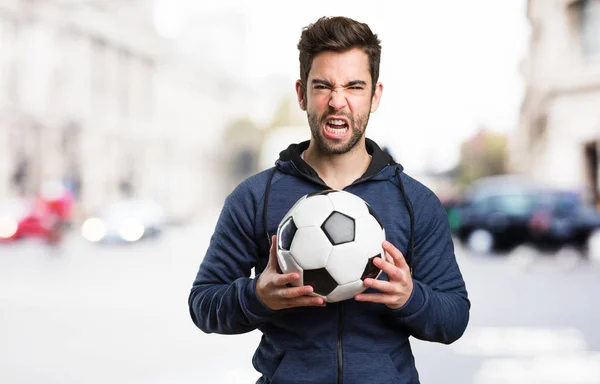 Angry Young Man Met Een Voetbal Onscherpe Achtergrond — Stockfoto