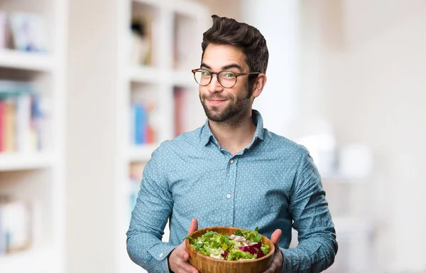 Young Man Holding Salad Blurred Background — Stock Photo, Image