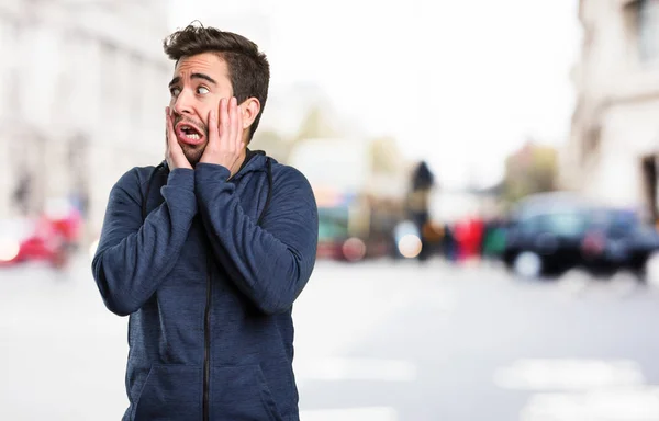 afraid young man on blurred background