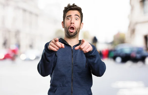 Joven Apuntando Frente Sobre Fondo Borroso — Foto de Stock