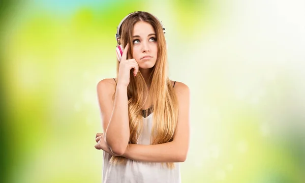 Woman Listening Music Headphones Blurred Green Background — Stock Photo, Image