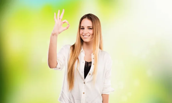 Pretty Young Woman Doing Okay Gesture Blurred Green Background — Stock Photo, Image