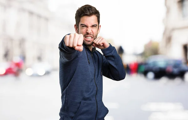 Young Man Punching Blurred Background — Stock Photo, Image