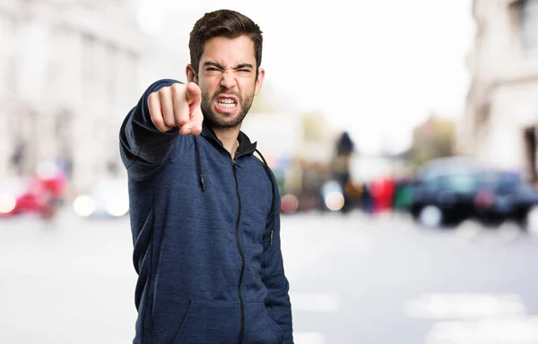 Young Man Pointing Front Blurred Background — Stock Photo, Image