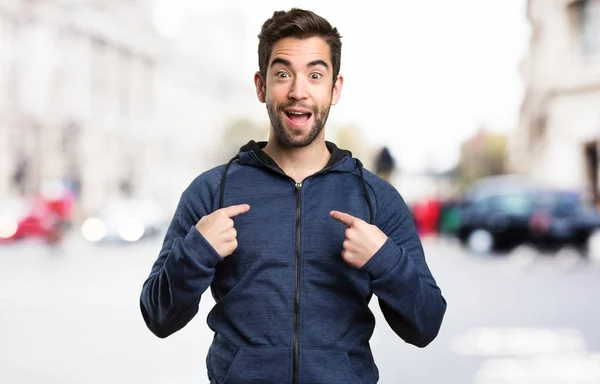 young man pointing himself on blurred background