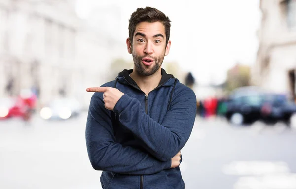 Young Man Pointing Space Blurred Background — Stock Photo, Image