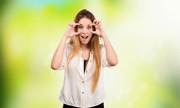 Pretty Young Woman Doing Opening Eyes Gesture Blurred Green Background — Stock Photo, Image