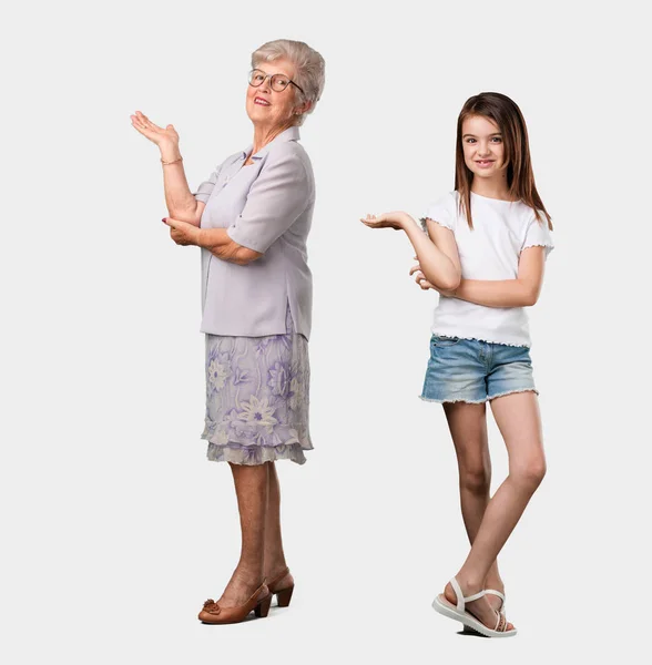 Full Body Elderly Lady Her Granddaughter Holding Something Hands Showing — Stock Photo, Image