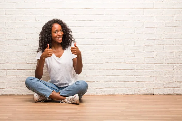 Young Black Woman Sitting Wooden Floor Cheerful Excited Smiling Raising — Stock Photo, Image