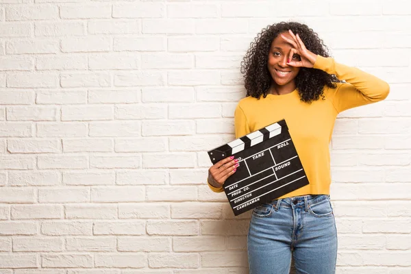 Young Black Woman Clapboard Cheerful Confident Doing Gesture Brick Wall — Stock Photo, Image