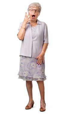 Full body senior woman very scared and afraid, desperate for something, cries of suffering and open eyes, concept of madness clipart