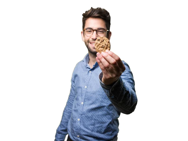 Mladý Muž Který Držel Cookie Izolovaných Bílém Pozadí — Stock fotografie