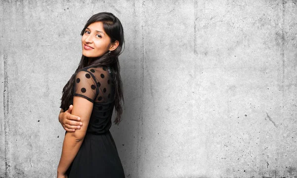 happy latin woman on grey background