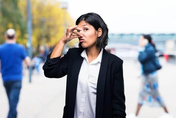 latin business woman smelling bad