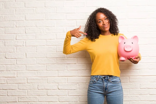 Young Black Woman Piggy Bank Proud Confident Pointing Finger Brick — Stock Photo, Image