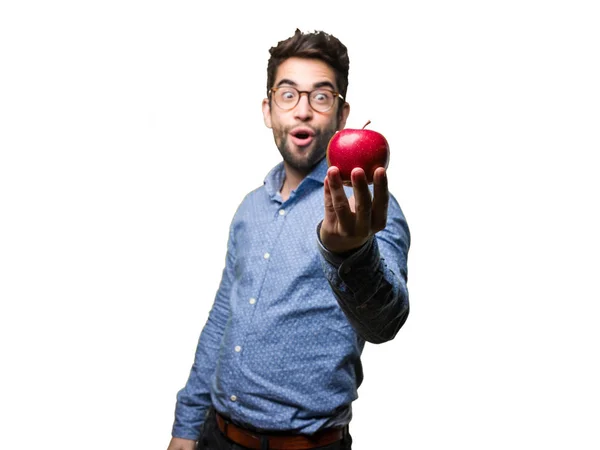 Joven Sorprendido Sosteniendo Una Manzana Aislada Sobre Fondo Blanco —  Fotos de Stock