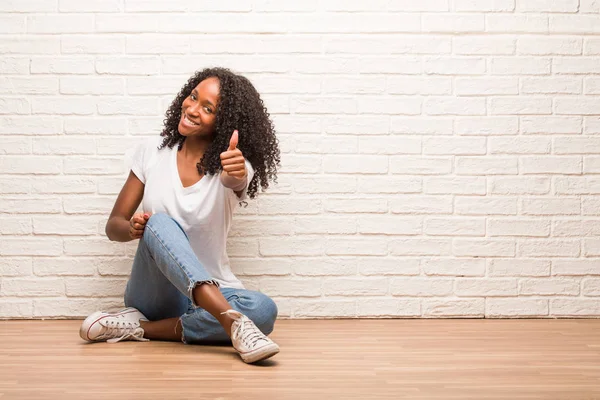 Young Black Woman Sitting Wooden Floor Cheerful Excited Smiling Raising — Stock Photo, Image