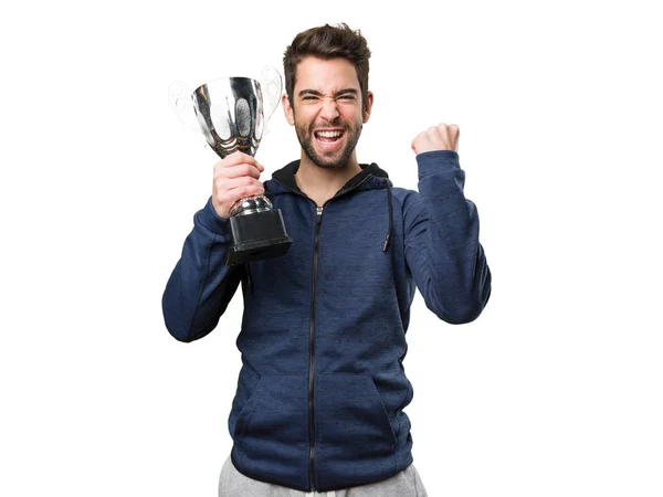 Mladý Muž Který Držel Trofej Dělá Vítěze Gesto Izolované Bílém — Stock fotografie