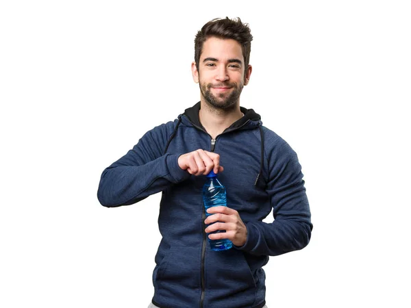 Šťastný Mladý Muž Který Držel Láhev Vody Izolovaných Bílém Pozadí — Stock fotografie