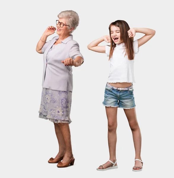 整个身体的老太太和她的孙女听音乐 跳舞和有乐趣 呼喊和表达幸福 自由的概念 — 图库照片