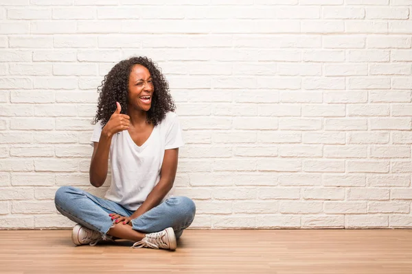 Young Black Woman Sitting Wooden Floor Cheerful Excited Smiling Raising — Stock Photo, Image