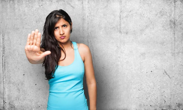 latin woman doing stop gesture