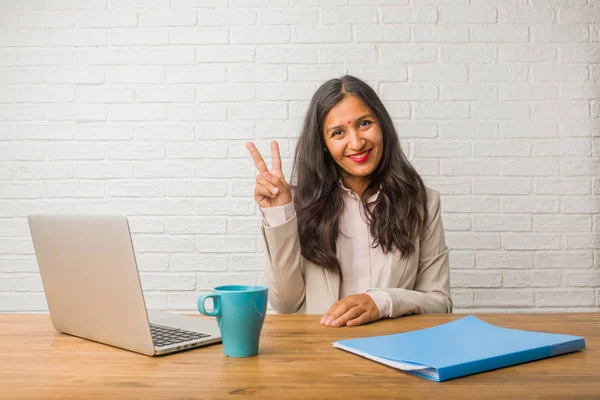 Young indian woman at office fun and happy