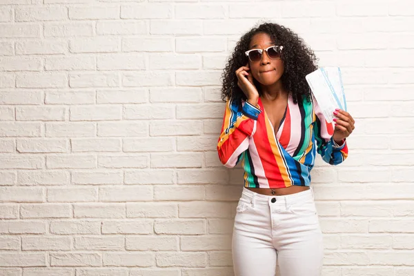 Young Black Woman Air Tickets Covering Ears Hand Brick Wall — Stock Photo, Image