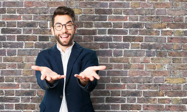 Young Man Offering Something Brick Wall — Stock Photo, Image