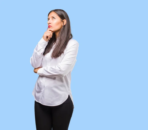 Portrait of young indian woman doubting and confused