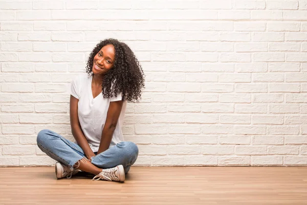 Young Black Woman Sitting Wooden Floor Cheerful Big Smile Brick — Stock Photo, Image