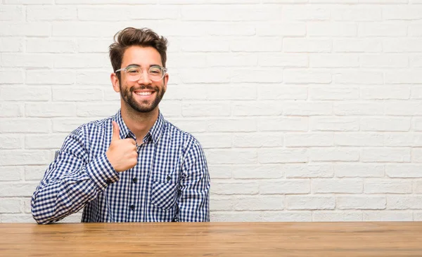 Giovane Uomo Caucasico Seduto Allegro Eccitato Sorridente Alzando Pollice Verso — Foto Stock