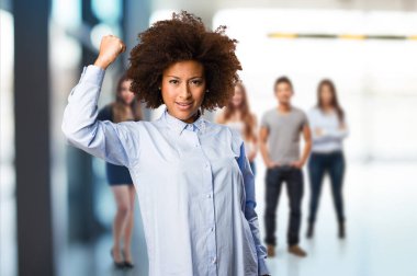 Genç siyah kadının arka plan bulanık kişi ile güçlü bir jest yapması