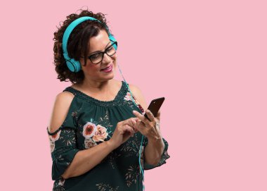 Onun cep telefonu ile müzik dinlemek, ritim hissetme ve yeni sanatçılar, gözleri kapalı keşfetmek rahat ve konsantre, orta yaşlı kadın