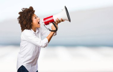 Genç siyah kadın üzerinde arka plan bulanık megafon bağırarak