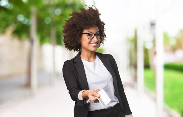 black business woman holding a credit card on blurred background