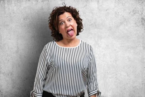中年女性自信と感情 楽しい 優しい 遊びや楽しみの印として舌を示す式 — ストック写真