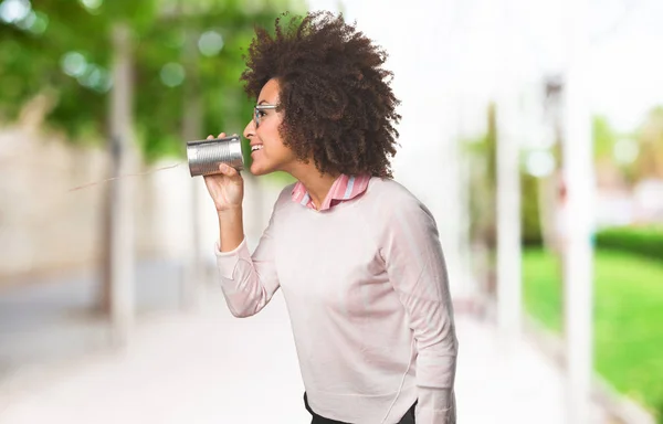 black woman holding tin can, selective focus