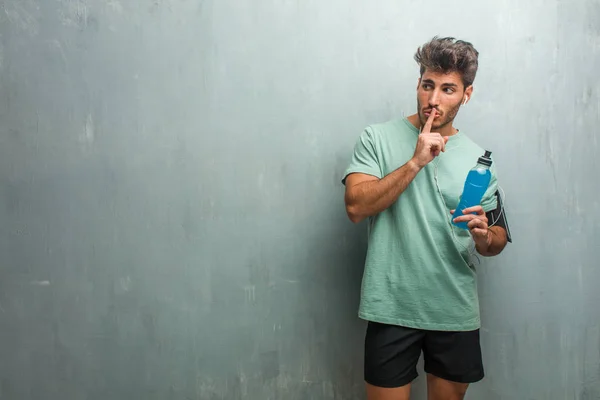 Young Fitness Man Grunge Wall Keeping Secret Asking Silence Holding — Stock Photo, Image
