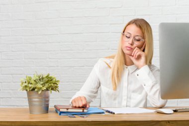 Görevleri şüphe ve karışık, düşünme, bir fikir ya da bir şey hakkında endişeli masasına oturan genç öğrenci portresi