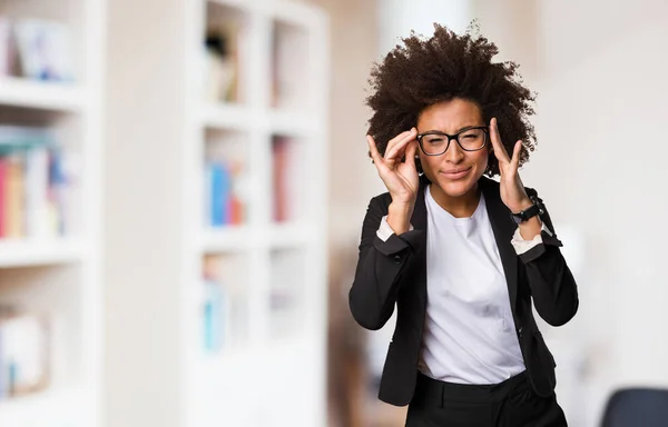 business black woman putting on glasses